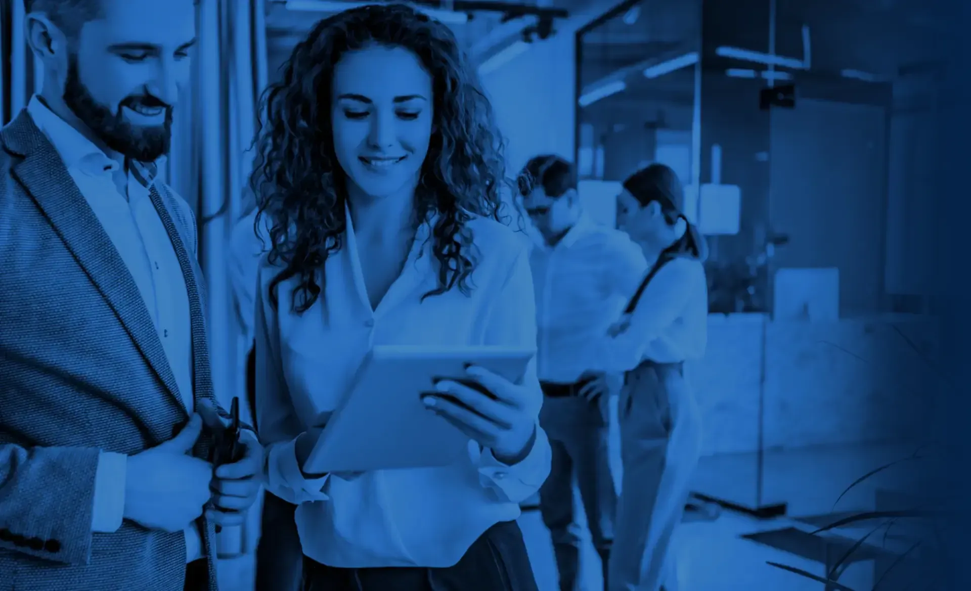 Business team collaborating with GoTo Connect across a modern office